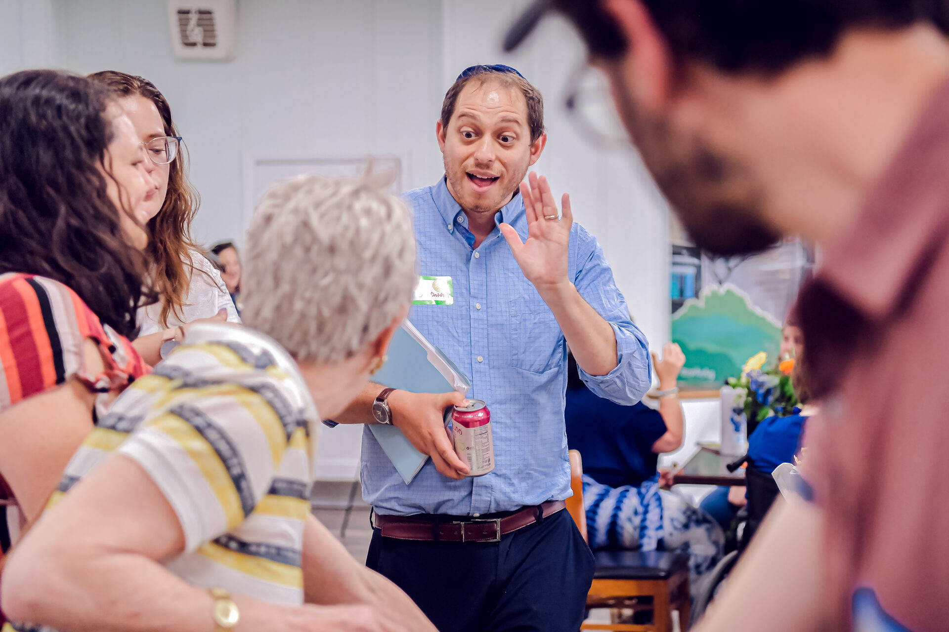 A man animatedly speaks to someone else in our beit midrash