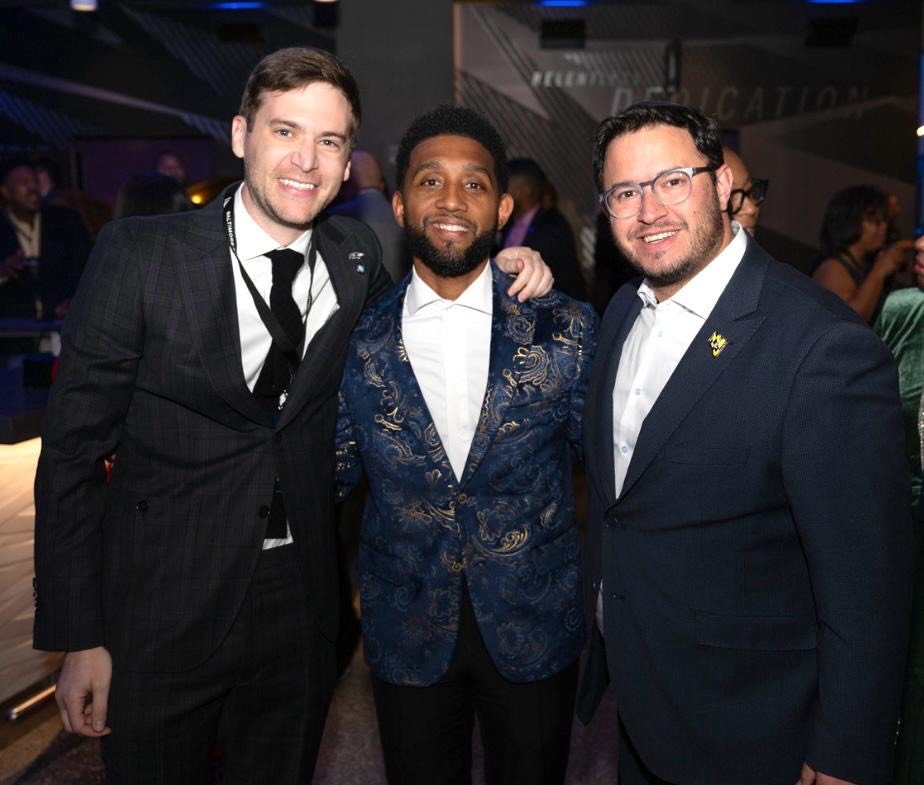 Adam Neuman and two athletes in suits