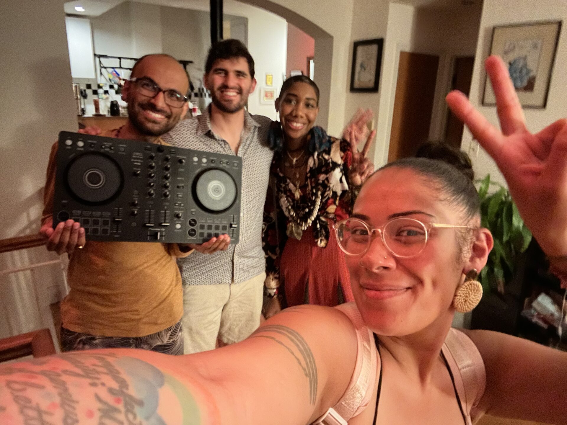 A group of people take a selfie with a boombox